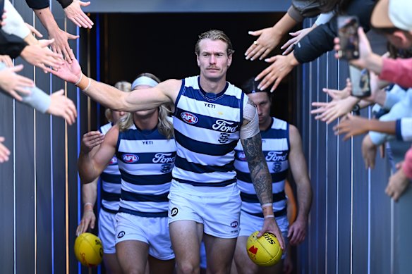 Tom Stewart leads the Cats out for their clash with the Hawks earlier this season.