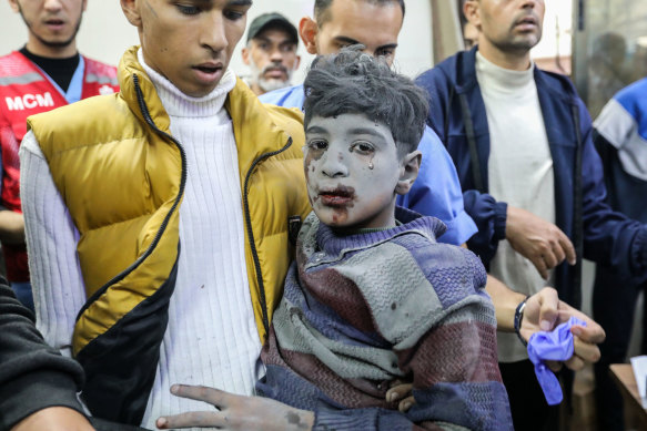 Palestinians injured in an Israeli airstrike arrive at Nasser Medical Hospital in Khan Younis, Gaza.