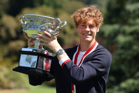 Jannik Sinner poses with the Australian Open trophy