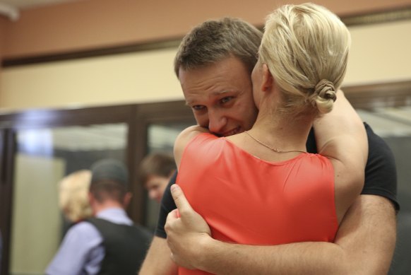 Russian opposition leader Alexei Navalny embraces his wife, Yulia, in a courtroom as he was released from custody in Kirov, Russia, 2013. 