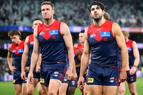 Christian Petracca and his Demons teammates look dejected after losing to Geelong.