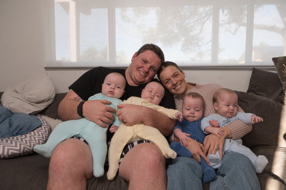 Sean Glachan, Taylah Tudehope-Glachan and their six-month-old quadruplets Archie, Billy, Charlie and Daisy at home at Buff Point on the NSW Central Coast.