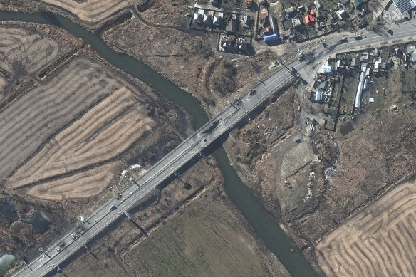 Destroyed vehicles and a damaged bridge in Irpin, Ukraine, west of Kyiv.