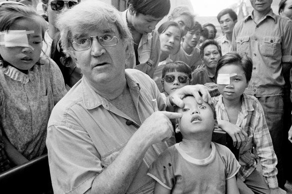 Fred Hollows examines the eye of Giap Van Tran in Hanoi in 1992.