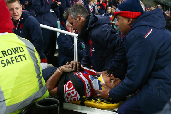Neck injury: Latrell Mitchell is stretchered off the field.