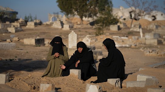 Fatma Abu Awad and her daughter Malak pray in a graveyard where their relatives who were killed by an Israeli airstrike are buried, in Khan Younis, Gaza, on Thursday.