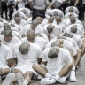 A prison guard transfers deportees from the US, alleged to be Venezuelan gang members, to the Terrorism Confinement Centre in Tecoluca, El Salvador.