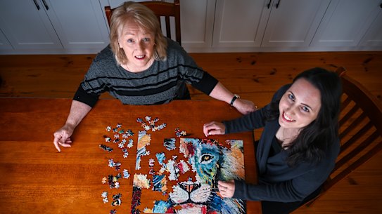 Competitive jigsaw puzzlers Bree Rebeiro, right, and her mother Jeanette Rebeiro practise at home.