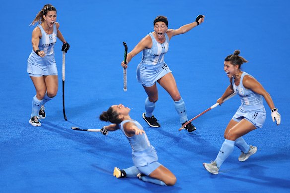 Maria Granatto of Argentina (obscured) celebrates scoring her team’s third goal with teammates during the women’s pool B match against Australia.