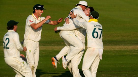 Matt Renshaw celebrates with teammates after taking a wicket on day four of the Test.