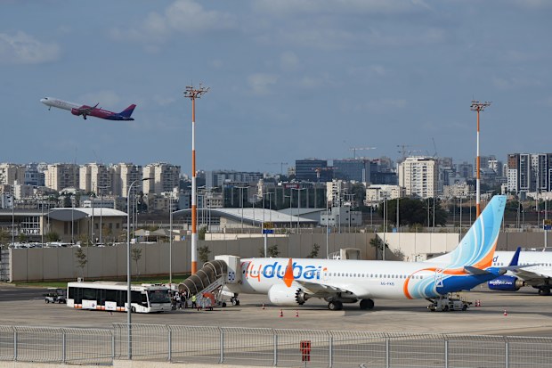 Passengers embark on a FlyDubai aircraft at Ben Gurion International Airport, near Tel Aviv, Israel, Wednesday, Sept. 30, 2026. (AP Photo/Ariel Schalit)