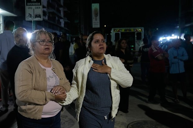 People remain outside their homes following an earthquake in Caracas, Venezuela, Thursday, June 25, 2026.