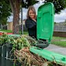 Jacky Stibilj inspects full bins in her neighbourhood which have not been collected.