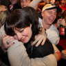 Embracing the moment: Labor supporters could tell where things were headed on Saturday night.