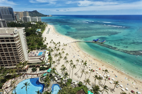 Aereal photo of Waikiki beach with view of Diamond Head mountain in the distance. iStock image for Traveller. Re-use permitted.