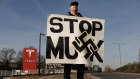 A protester stands outside a Tesla showroom in West London.