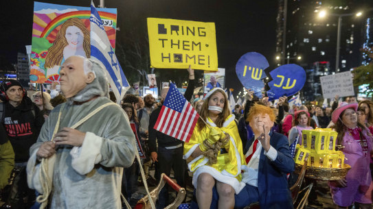 People dressed as US President-elect Donald Trump, right, and Israeli Prime Minister Benjamin Netanyahu, left, demand the Israeli government bring the hostage home from Gaza, in Tel Aviv, Israel.