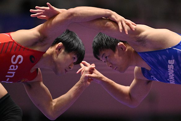 Toshihiro Hasegawa (red) and Rei Higuchi (blue) compete the Men’s Freestyle 61kg Final during day two of the All Japan Invitational Wrestling Championships at Komazawa at Komazawa Gymnasium in Tokyo, Japan.
