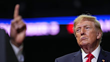 Donald Trump listens as gubernatorial candidate Vivek Ramaswamy speaks at a campaign rally earlier this month.