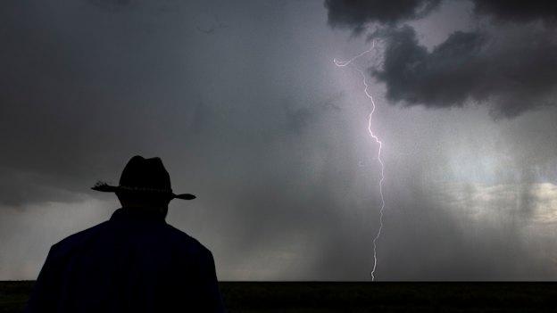 Gayini land manager Jamie Woods watches as a storm rolls in over the wetlands.