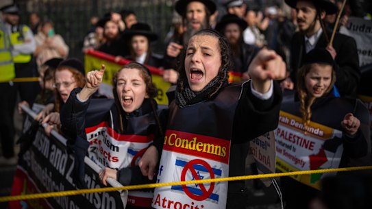 Anti-Zionist Orthodox Jewish children shout and gesture at pro-Israel supporters during a march to mark Al Quds Day and show solidarity with Palestinians in London, on April 5. Al Quds Day is celebrated worldwide on the last Friday of the holy month of Ramadan to show support for the Palestinians.