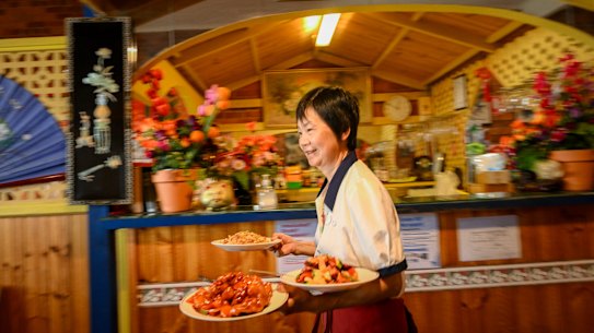 Connie Zhong serving BBQ pork chow mein and crispy sweet and sour fish at Flam Shan restaurant in Euroa