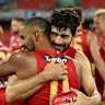 Petracca embraces teammate Touk Miller after the Norm Smith medallist’s stunning first game for the Suns.