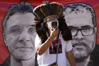 Indigenous leader Kamuu Wapichana speaks in front of a banner showing freelance British journalist Dom Phillips, left, and Indigenous expert Bruno Pereira, on Tuesday.