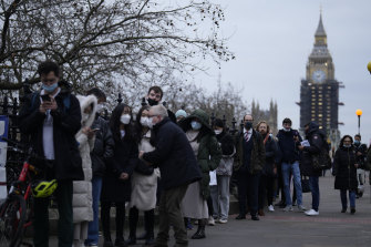Long lines have formed for booster shots across England as the British government urged all adults to protect themselves against the Omicron variant.  