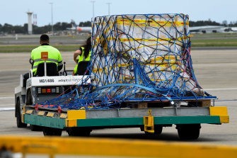 The first Australian shipment of Pfizer COVID-19 vaccines is seen being transported off the tarmac after landing at Sydney International Airport on Monday.