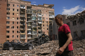 A man walks next to buildings and cars destroyed in a Russian bombing in Bakhmut in the Donetsk region in eastern Ukraine on May 24.