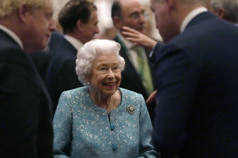 The Queen greets guests last week at Windsor Castle, alongside Prime Minister Boris Johnson.