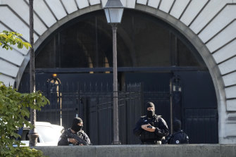 Security forces guard an entrance of the Palace of Justice in Paris during the trial.