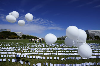 White flags representing people who have died of COVID-19 are displayed in protest of the government’s handling of the pandemic outside the National Congress in Brasilia, Brazil, last week.
