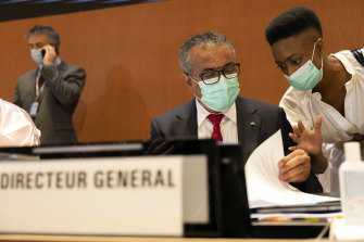 Tedros Adhanom Ghebreyesus, the Director General of the World Health Organisation (WHO), talks with a member of staff during the first day of the 75th World Health Assembly at the European headquarters of the United Nations in Geneva on Sunday. 