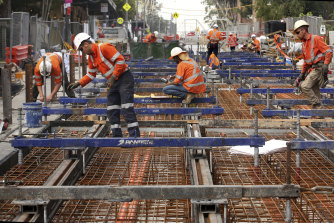 Construction workers and engineers hard at work on a major infrastructure project. 