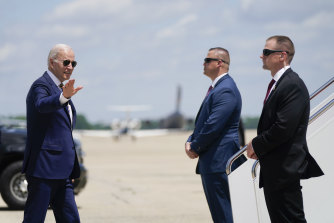US President Joe Biden waves as he walks to board Air Force One.