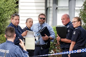Police outside the Spotswood home on Friday.