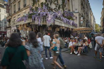 Packed cafes and restaurants on the Rue de Buci in Paris on Sunday.
