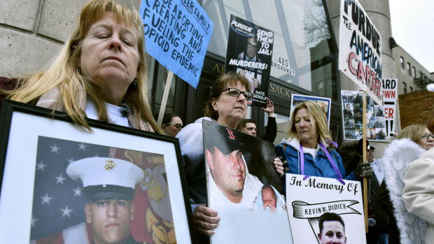 Kathleen Scarpone, left, and Cheryl Juaire, second from left, protest at Harvard University last week. Juaire, who's son Corey Merrill died in 2011, led a demonstration by parents who have lost a child to opioid abuse. 