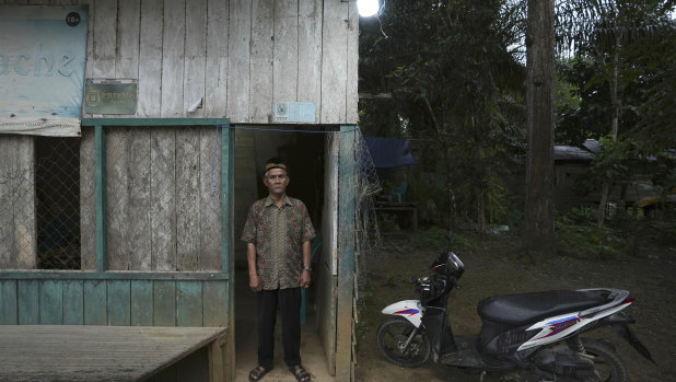 Balik leader Sib Kudin stands outside his home in Penyam Paser Utara, near where construction of Indonesia's new capital has begun.