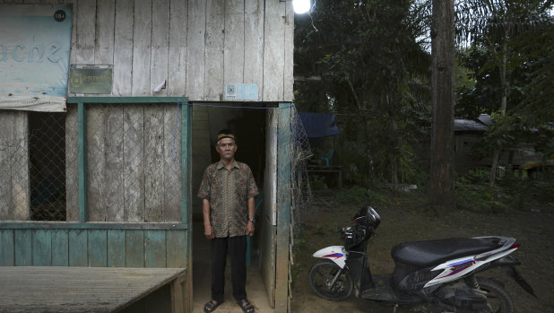 Balik tribe leader Sibukdin stands outside his house in Penajam Paser Utara near where construction has begun on Indonesia’s new capital city.