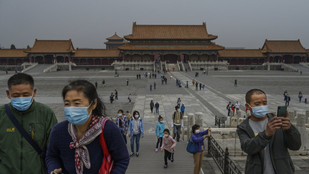 Visitors wear protective masks as they tour the Forbidden City, which recently re-opened to limited visitors, on May 7.