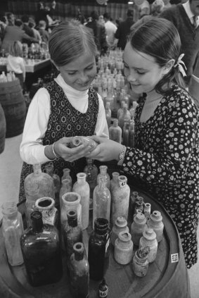 Deborah Pippen and Cassandra Davis examine  some of the bottles up for auction.