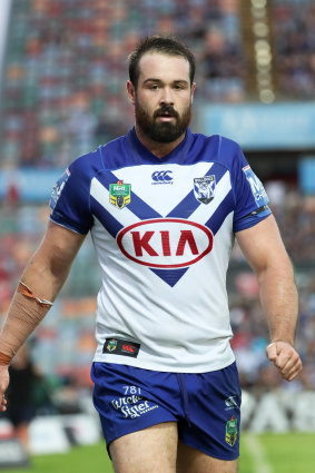 Unhappy beginning: Aaron Woods heads for the bench.