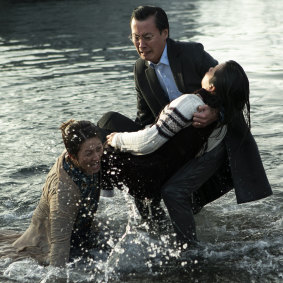 Lap Phan rescuing Jillian Nguyen with Oakley Kwon in a scene from <i>Hungry Ghosts</i>.