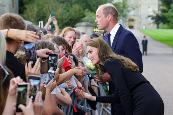 Catherine, the Princess of Wales, and Prince William, the Prince of Wales, meet mourners. 