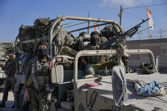 Israeli army troops are seen on the Israeli-Gaza border during a ground operation in the Gaza Strip on Wednesday.