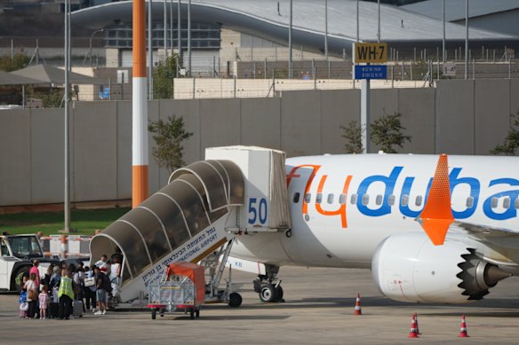 Passengers embark on a Flydubai aircraft at Ben Gurion International Airport, near Tel Aviv, Israel, Wednesday.