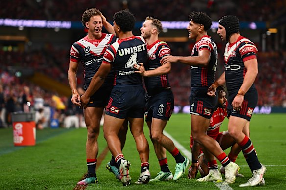 Mark Nawaqanitawase celebrates a try for the Roosters.